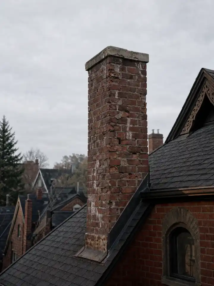 The same chimney before: crumbling bricks and open mortar joints