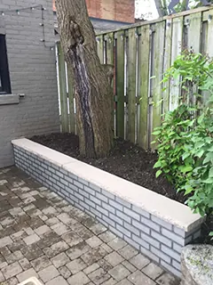 Brick retaining wall, limestone coping